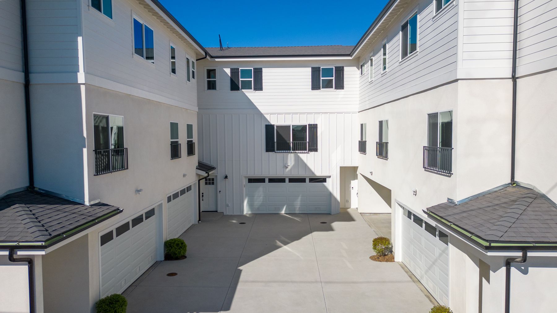 An elevated view into a private inner courtyard surrounded by a residential building.